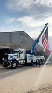 Randy's Towing wrecker with American flag